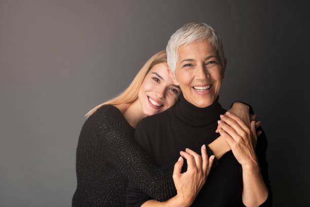 Moment with Mother Studio shot of mother and daughter. Both of them wearing black. grandma portrait stock pictures, royalty-free photos & images