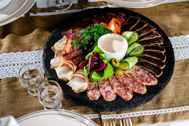 istock Appetizing meat set: beef slices, bacon, salami and vegetables o 984922740