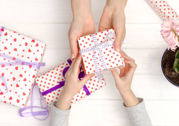 istock Mother and daughter making gifts 984958128