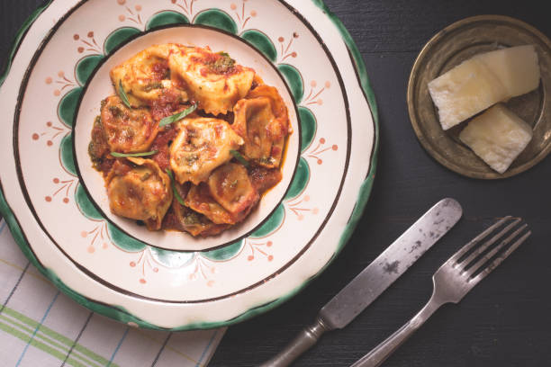 istock Traditional Italian Tortellini with Tomato Sauce, Mozzarella Cheese and Basil on Rustic Plate 984963224