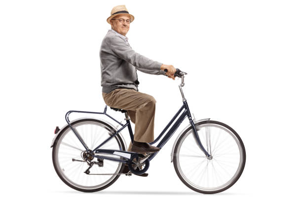 istock Senior riding a bike and looking at the camera 984963260
