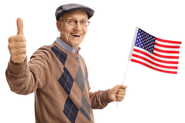 istock Senior holding an American flag and making a thumb up sign 984963338