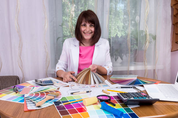 istock Beautiful designer showing laminate samples for renovation 984966282