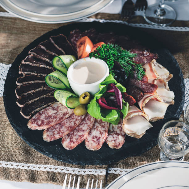 istock Appetizing meat set: beef slices, bacon, salami and vegetables o 984966692