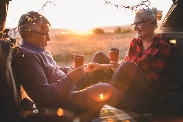 istock Senior couple sit in open car trunk before a hike 984969032