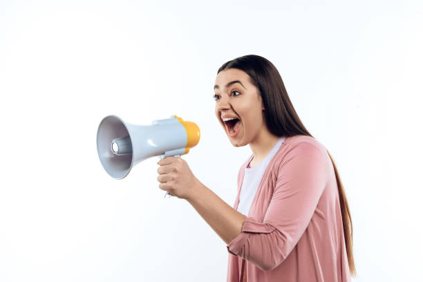 istock Young girl speaks into megaphone. 984976748