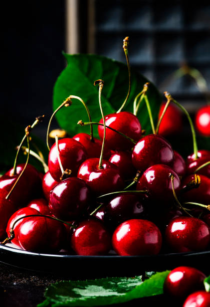 istock Red sweet cherries on brown table 984976888