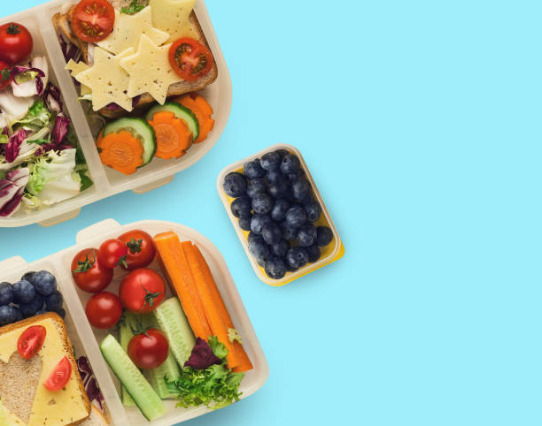 istock Lunch boxes with healthy food, isolated on blue 984977142