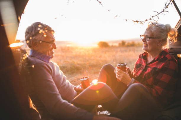 istock Senior couple sit in open car trunk before a hike 984978784