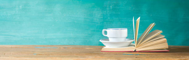 istock Open Book and a cup of coffee, panorama, good copy space 984978926