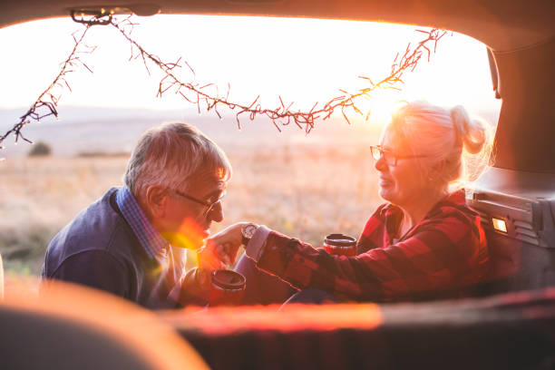 istock Senior couple sit in open car trunk before a hike 984982884