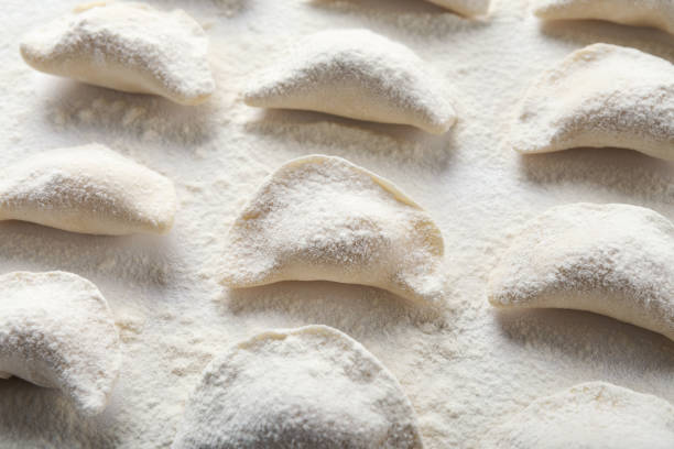 istock Raw handmade vareniki on table sprinkled with flour 984983448