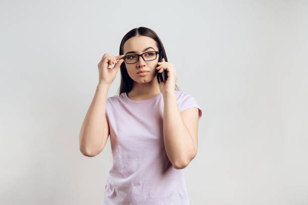 istock Young smart girl politely communicates on cell phone. 984983630