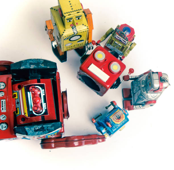 istock concept technical support;  woth a team of vintage robots fixing the big robots 984988804