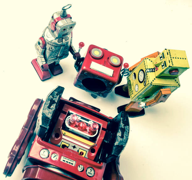 istock concept technical support;  woth a team of vintage robots fixing the big robots 984988820