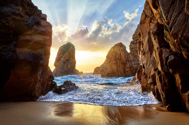 istock Sand beach among rocks on evening sunset 984991086
