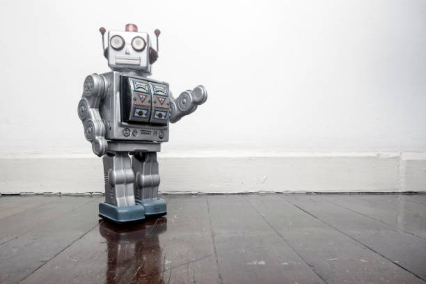 istock retro silver robot waving hi on an old wooden 984991124