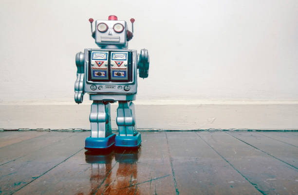 istock retro silver robot waving hi on an old wooden 984991164