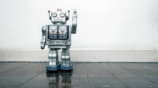 istock retro silver robot waving hi on an old wooden 984991228