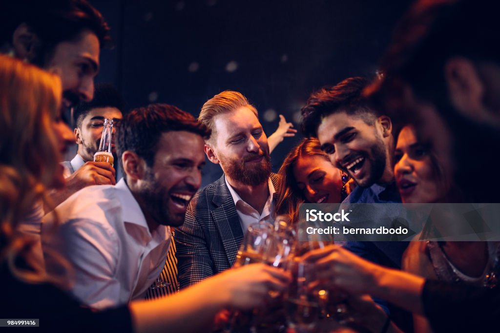 Here's to good times ! Group of friends toasting at a party Party - Social Event Stock Photo