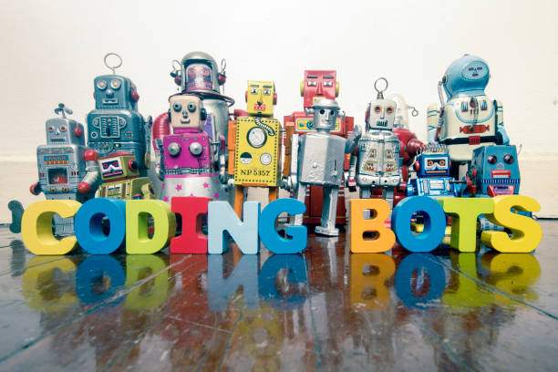 istock a team of vintage robots on a old wooden floor  with the word CODING BOTS 984994342