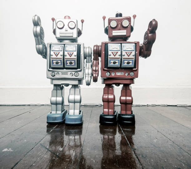 istock two vintage robots say hi  on a wooden floor toned 985000362