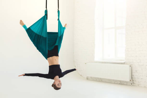istock Woman practicing fly yoga over white background 985001456