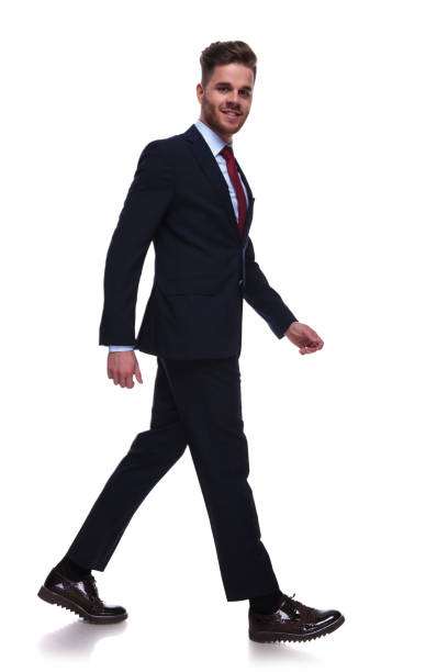 istock businessman in navy suit and red tie stepping to side 985002214