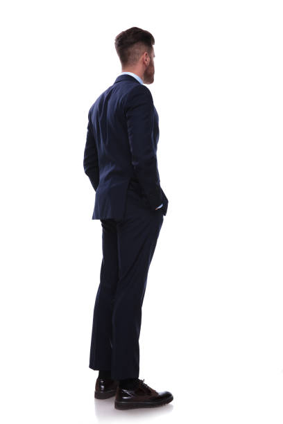 istock turned businessman in navy suit looks to side 985002742