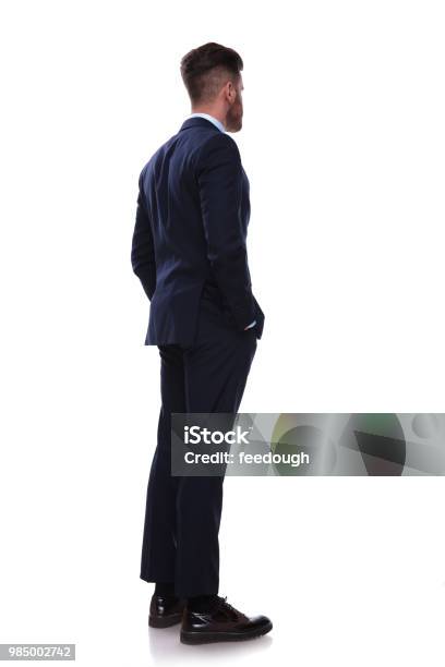 Turned Businessman In Navy Suit Looks To Side Stock Photo - Download Image Now - Rear View, Men, Back