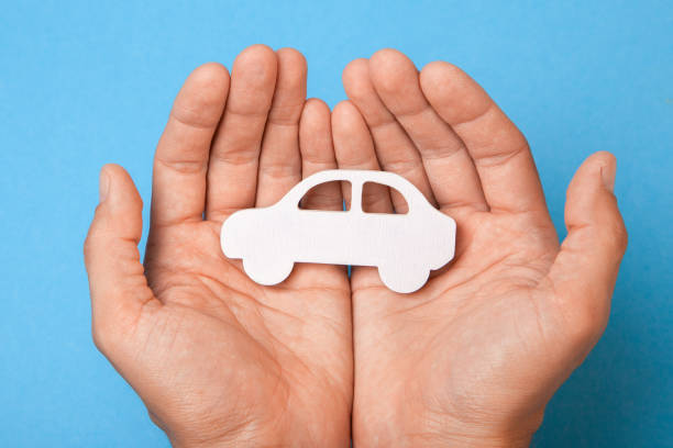 istock Car insurance. Man is holding car 985005174