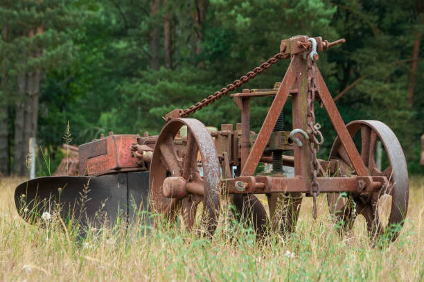Vintage rusty harvesting device as scrap metal in landscape