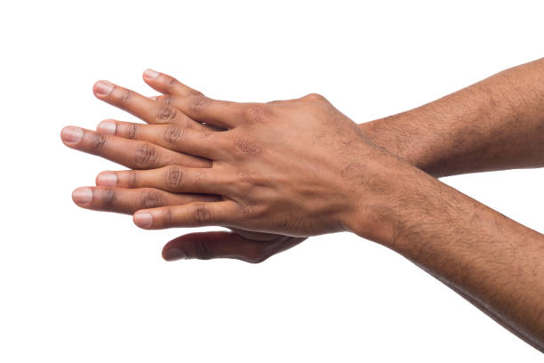istock Black man applying hand cream at white isolated background 985007790