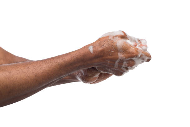 istock Black man washing hands isolated on white background 985007958