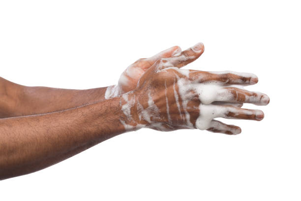 istock Black man washing hands isolated on white background 985008008