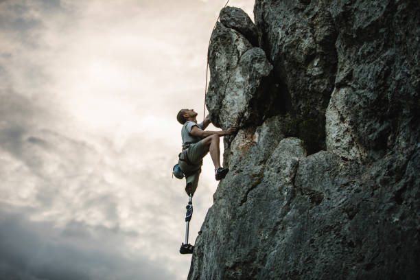 istock Disability man with prosthetic leg climbing 985012606