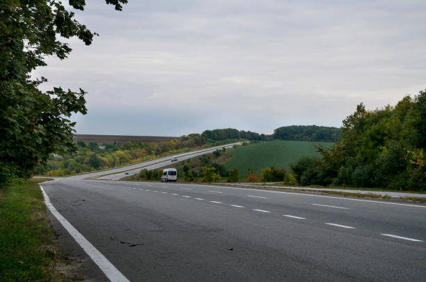 istock asphalt road between the bright autumn trees 985018878