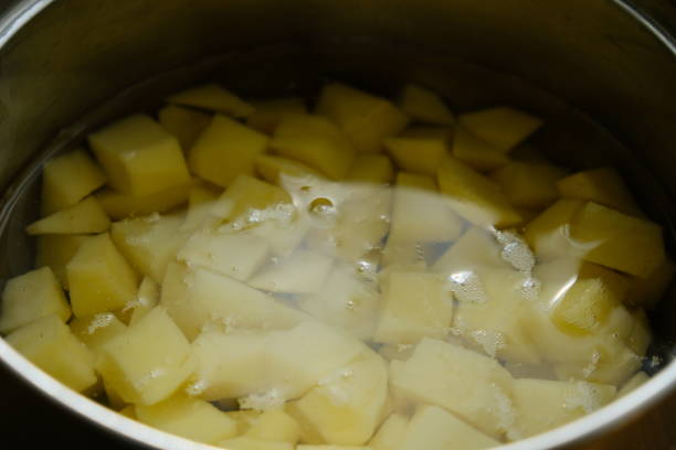 istock Sliced potatoes in water in a metal bowl 985019352