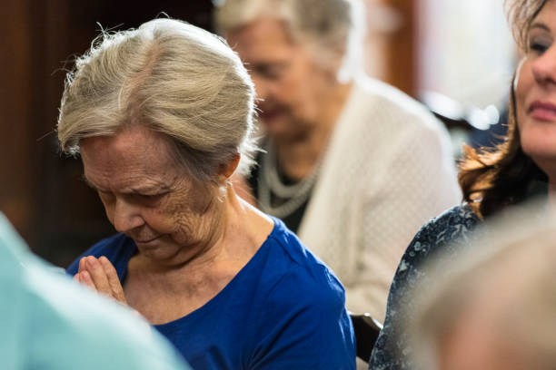 istock Women praying in church 985023506