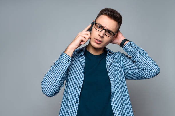 istock Young smart guy with glasses speaks on phone 985024314