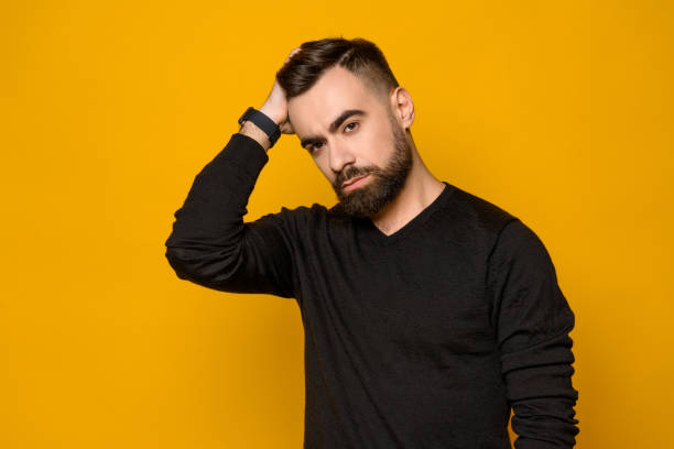 istock Handsome confident man combs hair isolated 985024438