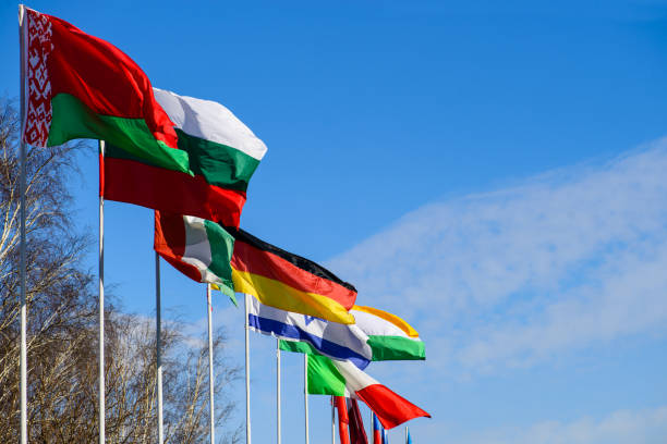 istock International summit. Flags of different countries blowing in th 985024744