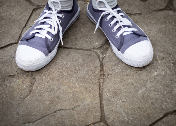 istock Top view of sneakers on legs 985025128