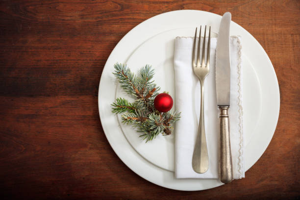 istock Christmas place setting with decoration on wooden background 985025212