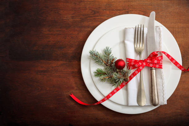 istock Christmas place setting with decoration on wooden background 985025348