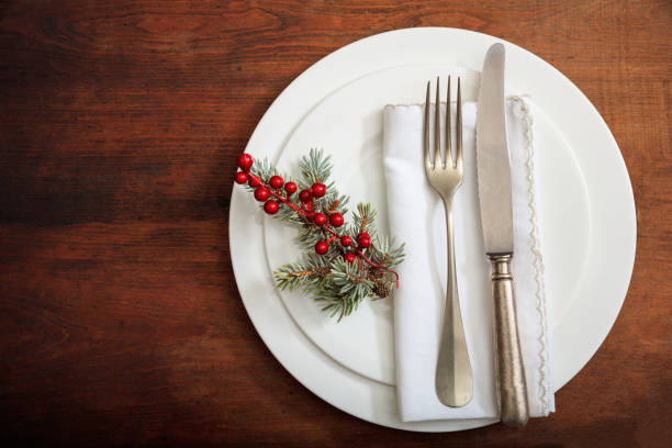 istock Christmas place setting with decoration on wooden background 985025568