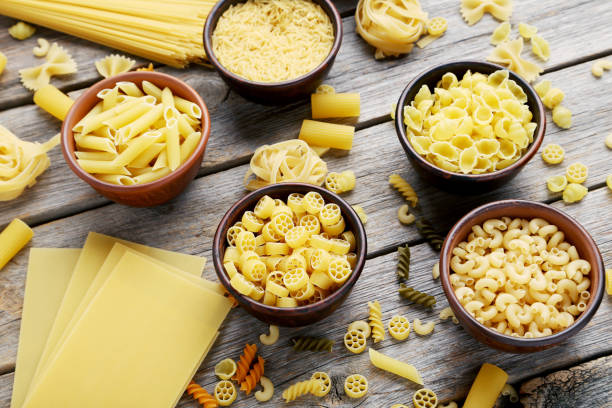 istock Different kinds of pasta in bowls on grey table 985027814