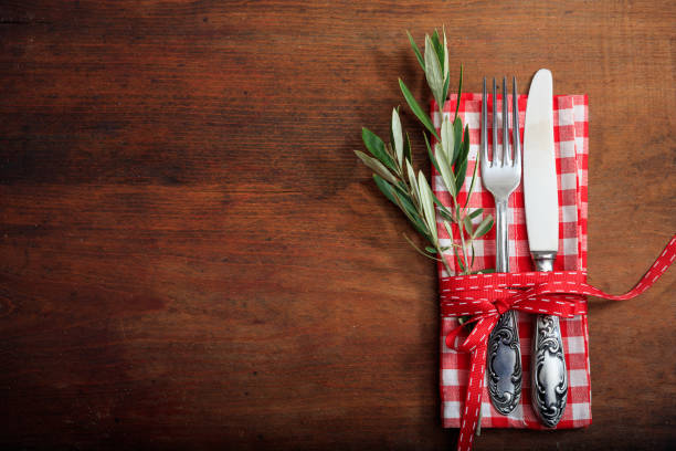 istock Table setting with fork knife and linen on wooden background 985028742