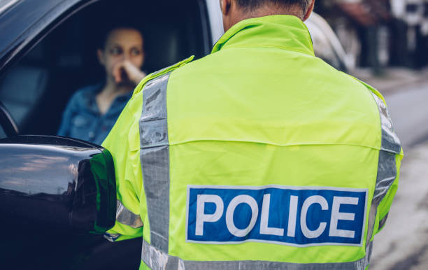 istock Young woman pulled over by traffic police 985028862
