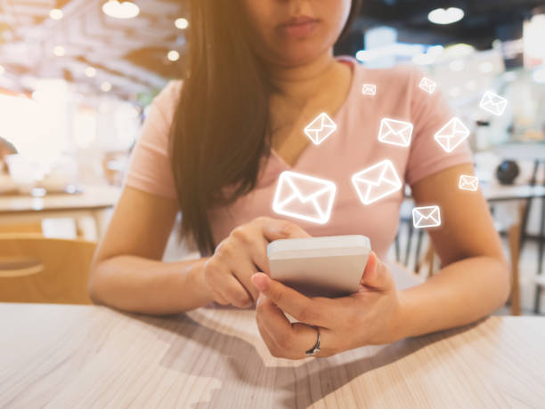 istock E-mail marketing and newsletter concept, Woman hand using sending message by email application in mobile phone 985029334